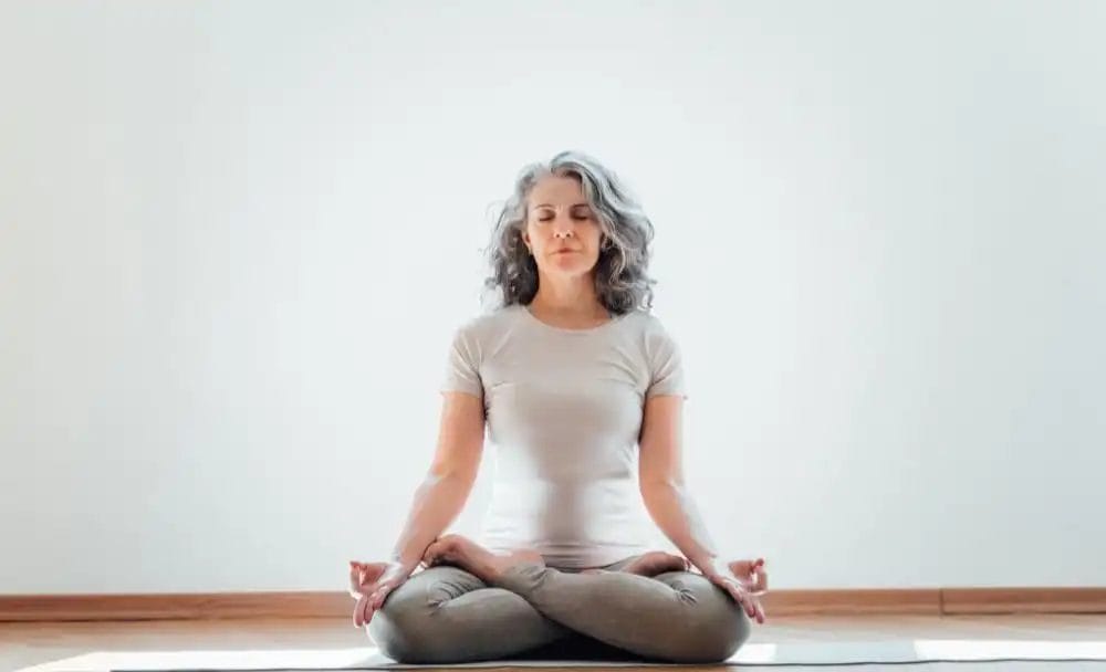 Young Woman Doing Yoga Padmasana Pose Variation On Dark Room Stock Photo -  Download Image Now - iStock