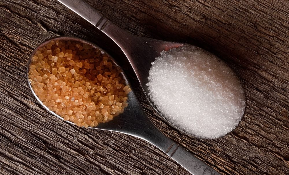 How are brown and white sugars different in texture?