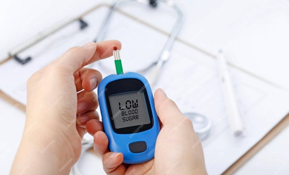 hand holding blood glucose meter measuring blood sugar background is stethoscope chart file 1387 943